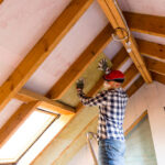 Man installing Ceiling insulation