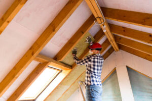 Man installing Ceiling insulation